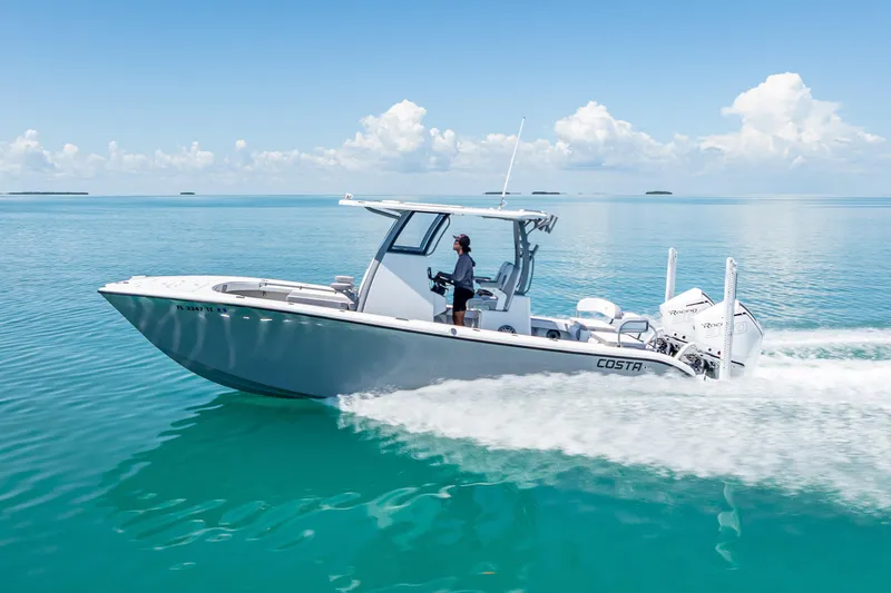  Yacht Photos Pics 2022 Costa Custom Boats 264 cruising on clear blue water under a sunny sky.