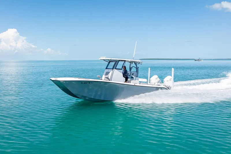  Yacht Photos Pics 2022 Costa Custom Boats 264 cruising on clear blue water under a sunny sky.