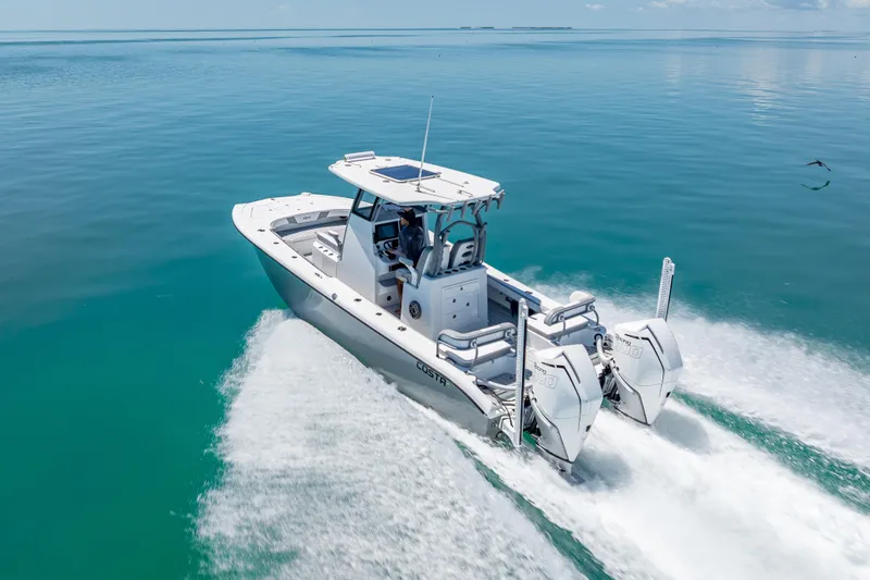  Yacht Photos Pics 2022 Costa Custom Boats 264 cruising on clear blue water, showcasing sleek design and powerful engines.