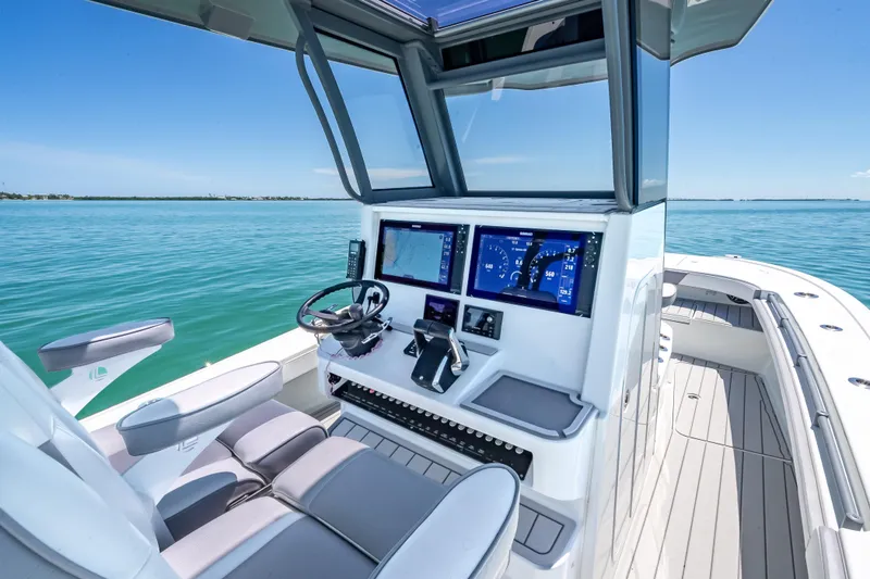 Yacht Photos Pics 2022 Costa Custom Boats 264 helm with modern controls on calm blue water.
