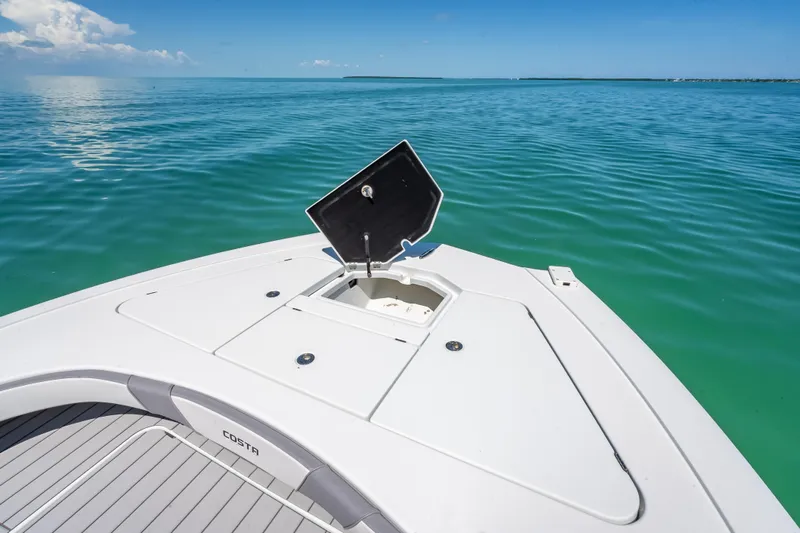  Yacht Photos Pics 2022 Costa Custom Boats 264 on calm blue water, open hatch on deck.