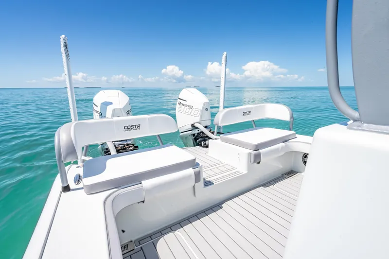  Yacht Photos Pics 2022 Costa Custom Boats 264 on clear blue water, featuring dual engines and seating.