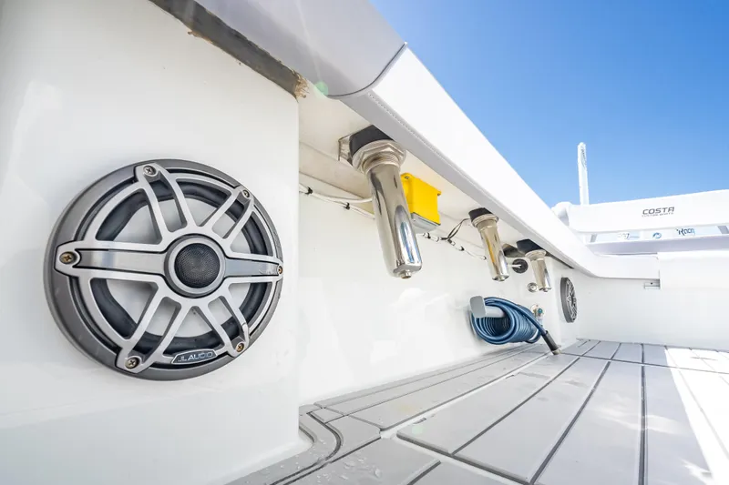  Yacht Photos Pics 2022 Costa Custom Boats 264 deck with speakers and rod holders under clear blue sky.