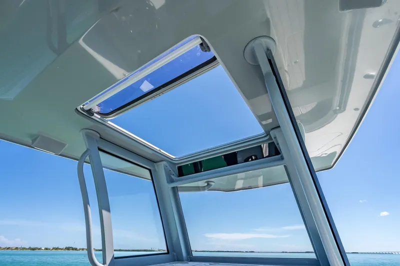  Yacht Photos Pics 2022 Costa Custom Boats 264 with open sunroof, showcasing clear blue sky and ocean.