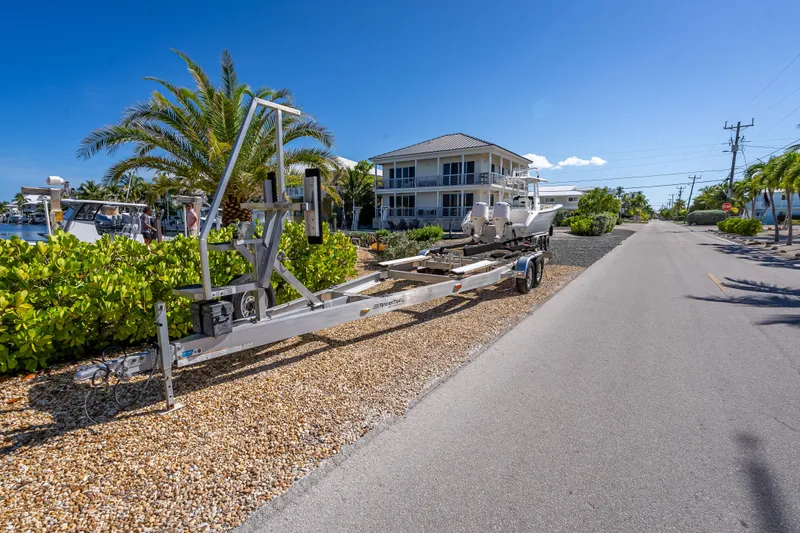  Yacht Photos Pics 2022 Costa Custom Boats 264 on trailer near waterfront home, sunny day.