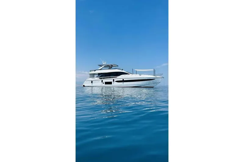 Koko Yacht Photos Pics 2023 Azimut Fly 78 yacht on calm blue water under clear sky.