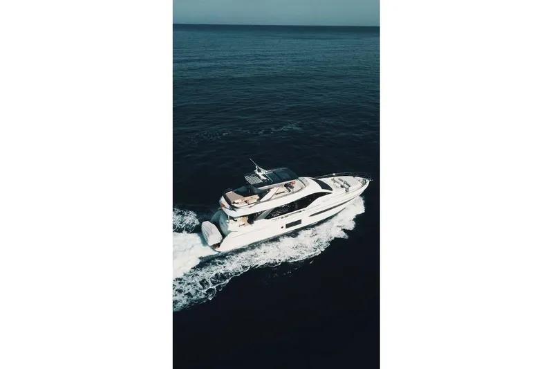 Koko Yacht Photos Pics 2023 Azimut Fly 78 yacht cruising on open sea, aerial view.
