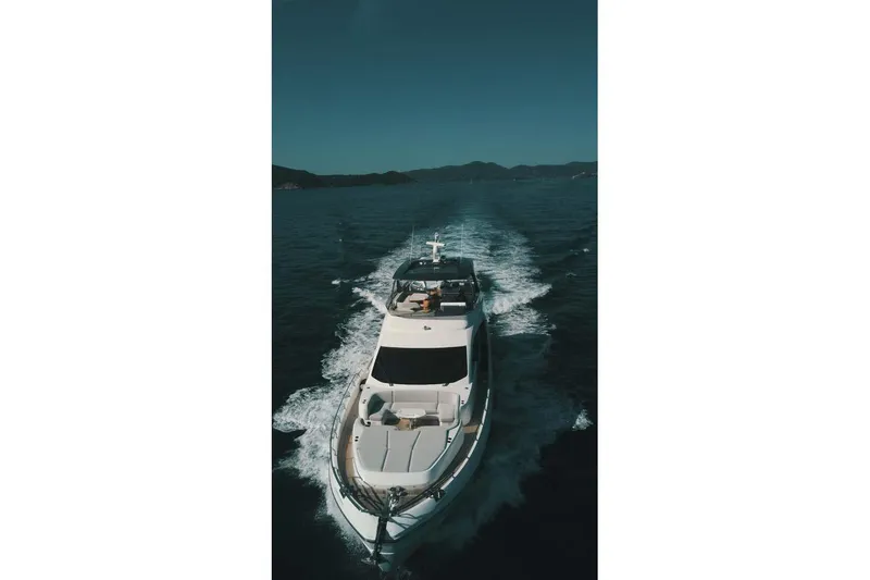 Koko Yacht Photos Pics 2023 Azimut Fly 78 yacht cruising on open water, aerial view.