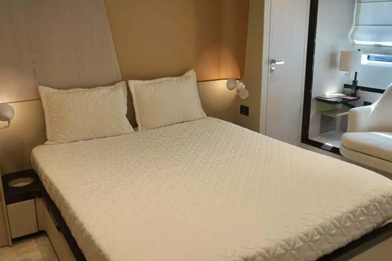 Koko Yacht Photos Pics Luxurious bedroom interior of 2023 Azimut Fly 78 yacht, featuring elegant bedding and modern decor.