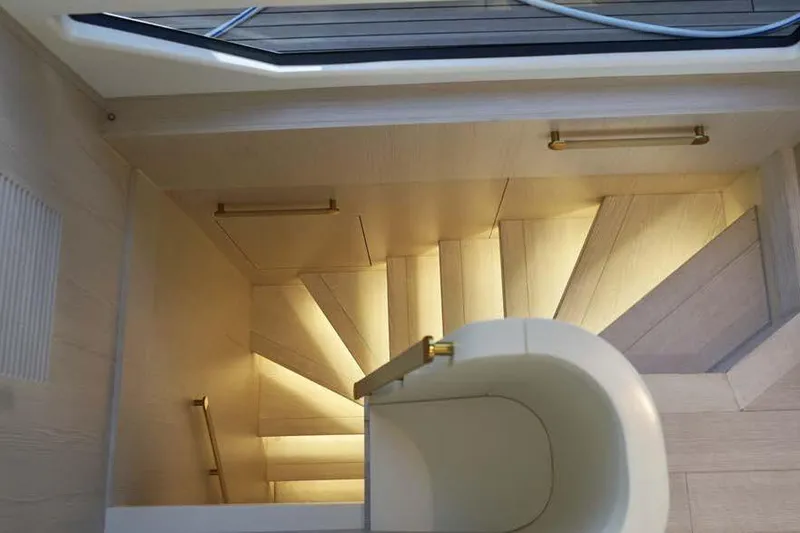 Koko Yacht Photos Pics Luxurious interior staircase of 2023 Azimut Fly 78 yacht, featuring elegant lighting and modern design.