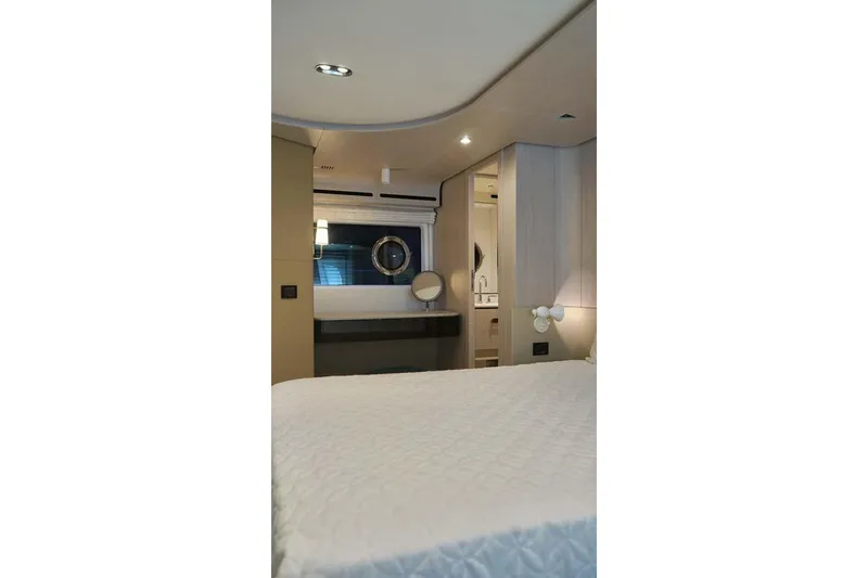 Koko Yacht Photos Pics Luxurious interior of 2023 Azimut Fly 78 yacht bedroom with modern design and elegant furnishings.