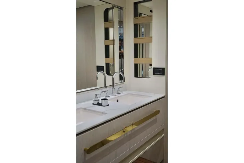 Koko Yacht Photos Pics Luxurious bathroom vanity in 2023 Azimut Fly 78 yacht, featuring dual sinks and modern fixtures.