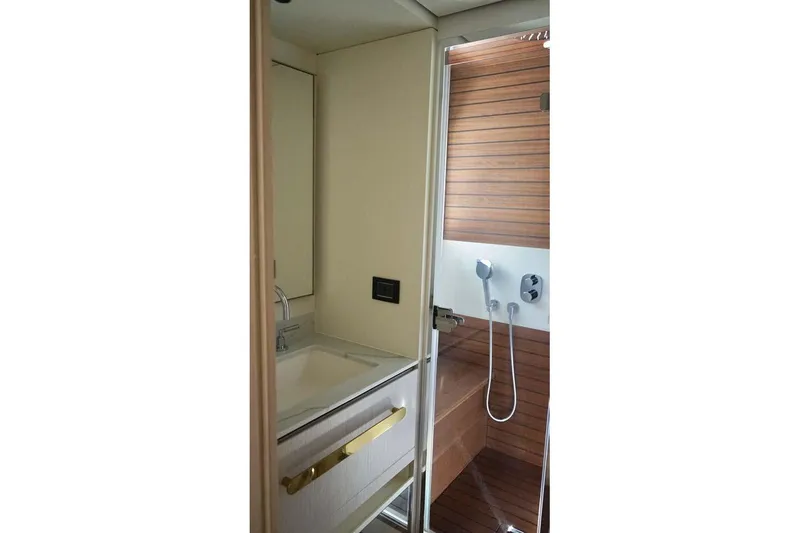 Koko Yacht Photos Pics Luxurious bathroom in 2023 Azimut Fly 78 yacht with modern fixtures and wooden accents.