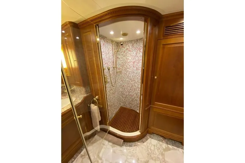  Yacht Photos Pics Luxurious shower in 2004 Benetti Tradition 100 yacht, featuring elegant wood and marble finishes.