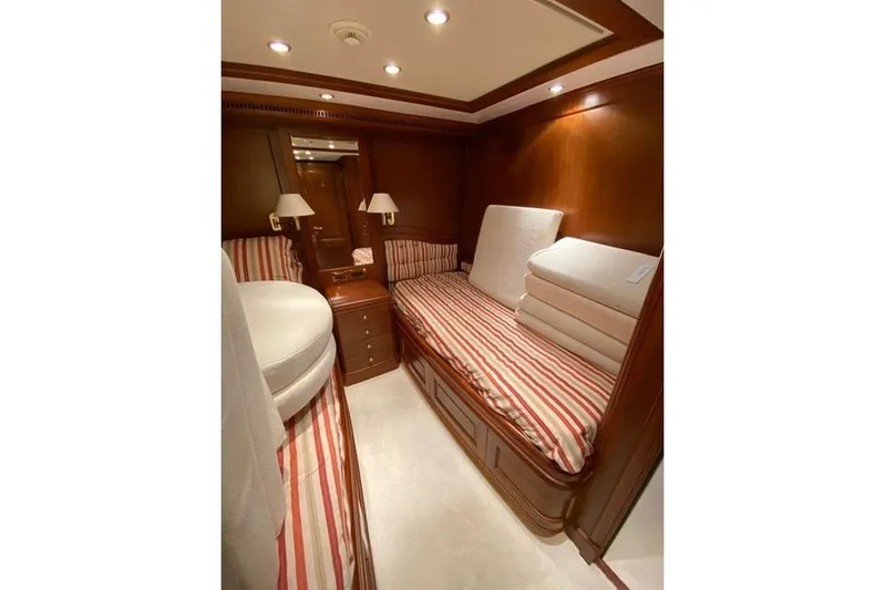  Yacht Photos Pics Luxurious cabin interior of 2004 Benetti Tradition 100 yacht with striped bedding.