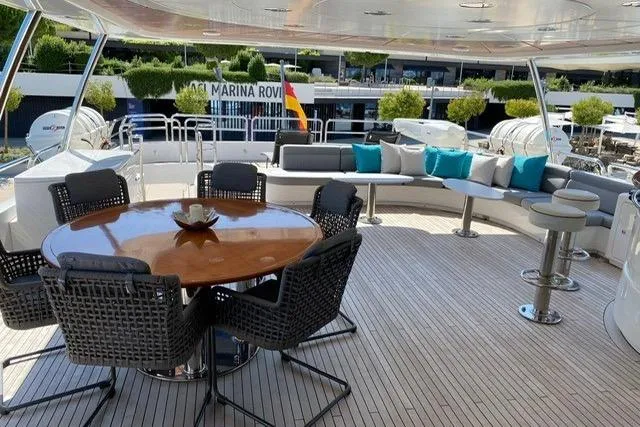  Yacht Photos Pics Luxurious 2004 Benetti Tradition 100 yacht deck with elegant seating and dining area.