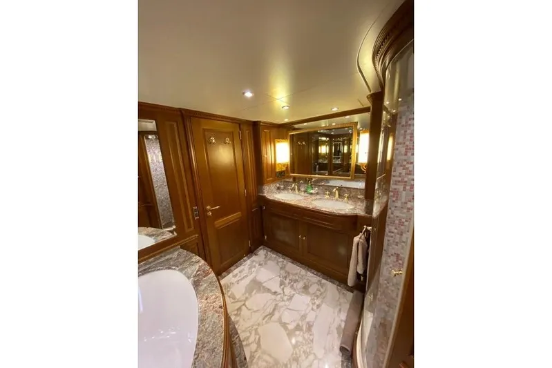  Yacht Photos Pics Luxurious bathroom interior on 2004 Benetti Tradition 100 yacht, featuring marble and wood finishes.