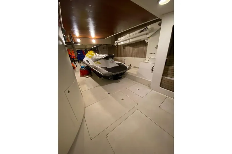  Yacht Photos Pics Interior of 2004 Benetti Tradition 100 yacht with jet ski in storage area.