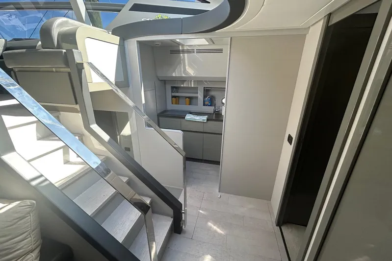 Habeas Orcas Yacht Photos Pics Modern interior of a 2020 Pershing 62 yacht with sleek stairs and minimalist design.