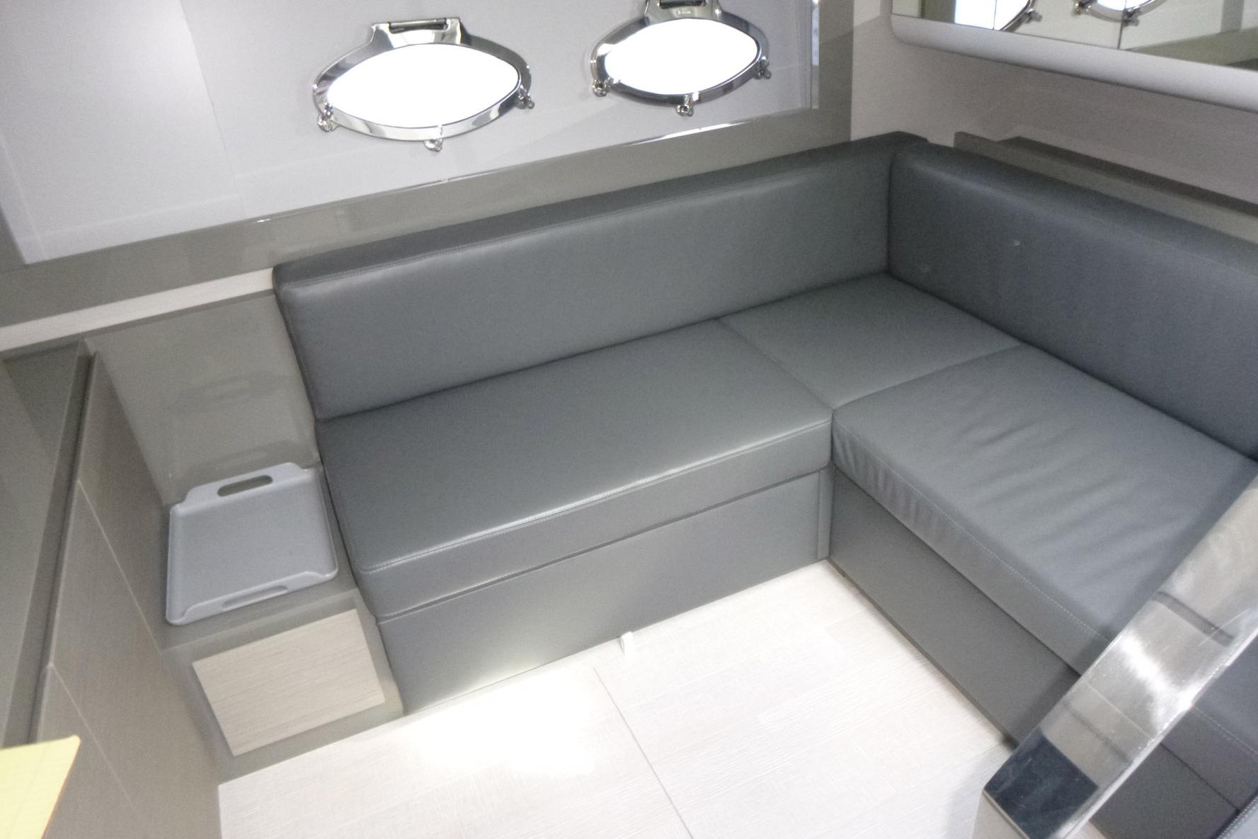Luxurious interior of 2020 Pershing 62 yacht with sleek gray seating and modern design.