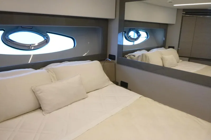 Habeas Orcas Yacht Photos Pics Luxurious bedroom interior of 2020 Pershing 62 yacht with elegant bedding and porthole window.
