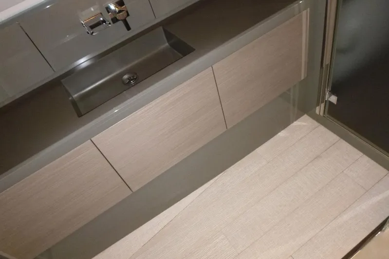 Habeas Orcas Yacht Photos Pics Modern bathroom sink and cabinet in a 2020 Pershing 62 yacht.