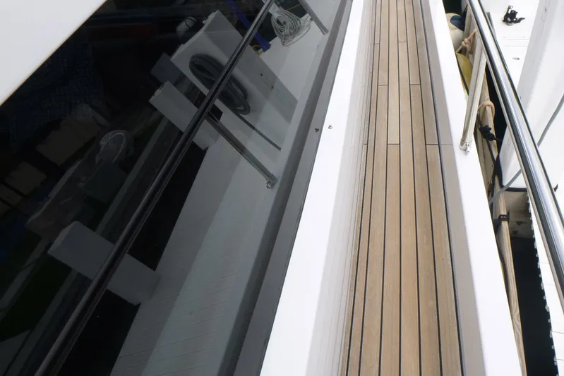 Habeas Orcas Yacht Photos Pics Side deck of a 2020 Pershing 62 yacht with sleek design and wooden flooring.