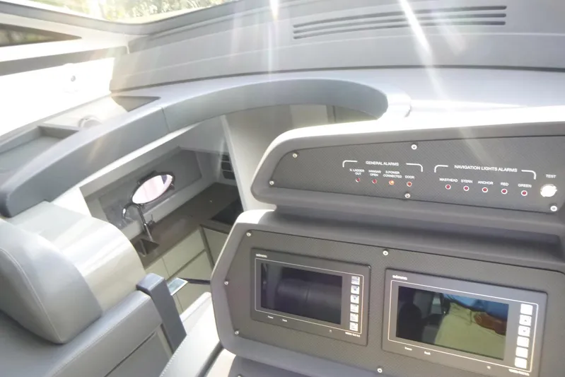 Habeas Orcas Yacht Photos Pics Interior view of 2020 Pershing 62 yacht cockpit with control panels and navigation displays.