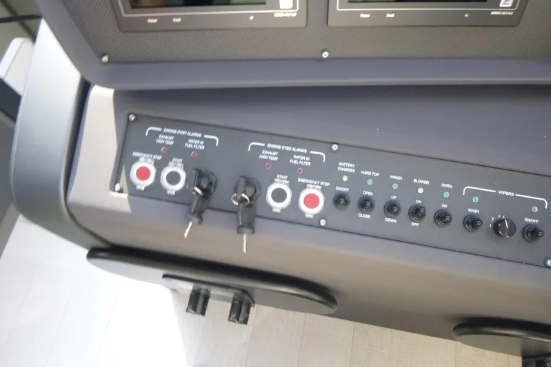 Habeas Orcas Yacht Photos Pics Control panel of a 2020 Pershing 62 yacht with various switches and keys.
