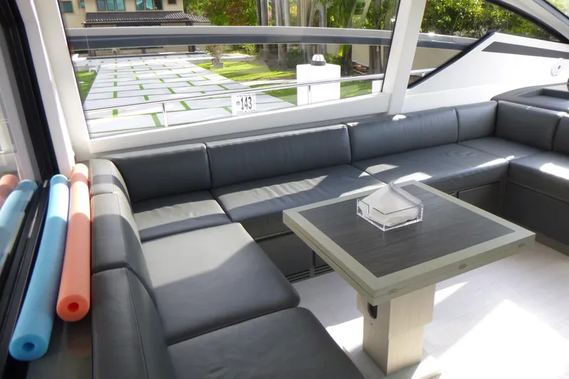 Habeas Orcas Yacht Photos Pics Luxurious interior of 2020 Pershing 62 yacht with sleek seating and modern table design.