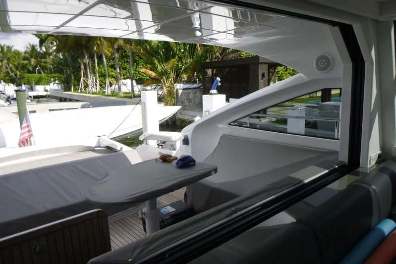 Habeas Orcas Yacht Photos Pics Luxury Pershing 62 yacht interior with sleek design, docked near tropical greenery, 2020 model.