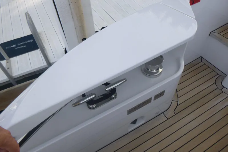 Habeas Orcas Yacht Photos Pics 2020 Pershing 62 yacht deck with sleek white railing and wooden flooring.