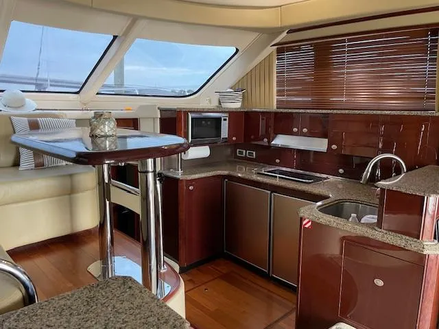  Yacht Photos Pics Luxurious interior of 2007 Sea Ray 52 Sedan Bridge yacht kitchen area.