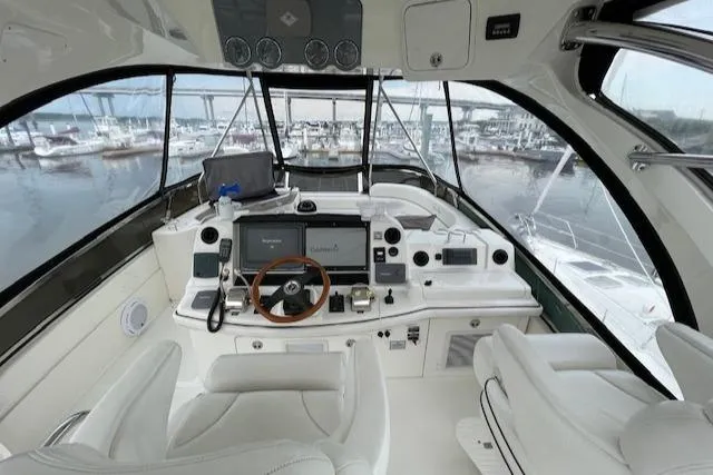  Yacht Photos Pics 2007 Sea Ray 52 Sedan Bridge helm with marina view, featuring modern navigation equipment.