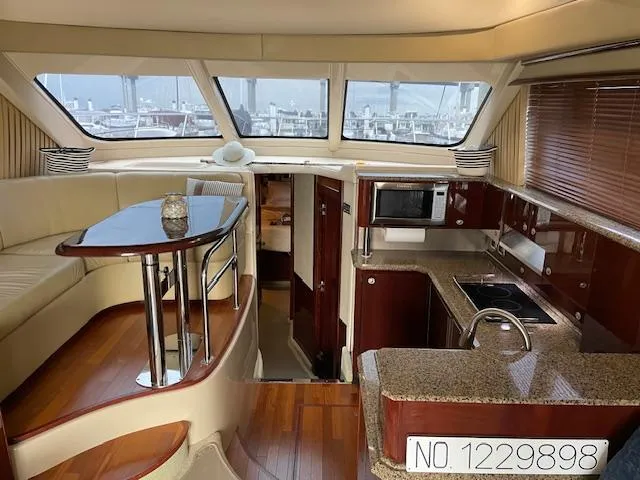  Yacht Photos Pics Luxurious interior of 2007 Sea Ray 52 Sedan Bridge yacht with modern kitchen and seating area.