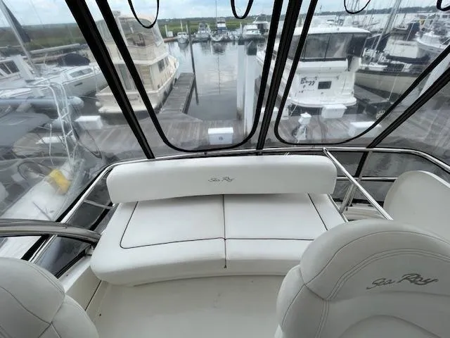  Yacht Photos Pics 2007 Sea Ray 52 Sedan Bridge interior with marina view, featuring white seating.
