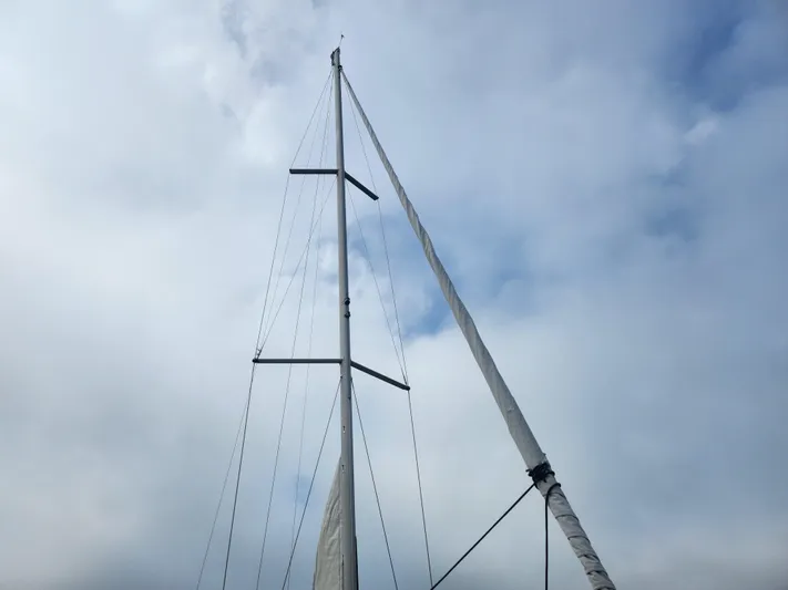 Vilia Yacht Photos Pics Mast of 2010 Jeanneau 45DS sailboat against cloudy sky.