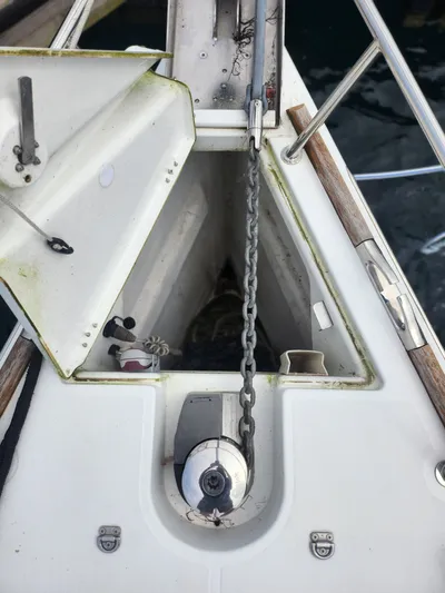 Vilia Yacht Photos Pics Anchor chain compartment on a 2010 Jeanneau 45DS sailboat, featuring open hatch and winch.