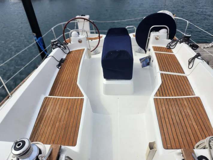 Vilia Yacht Photos Pics Cockpit of 2010 Jeanneau 45DS sailboat with wooden seating and steering wheel.