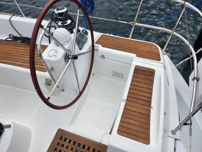 Vilia Yacht Photos Pics Cockpit of 2010 Jeanneau 45DS sailboat with wooden accents and steering wheel.