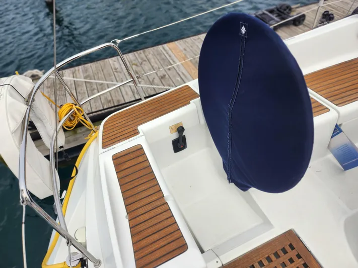 Vilia Yacht Photos Pics Jeanneau 45DS 2010 sailboat deck with wooden accents and covered steering wheel.