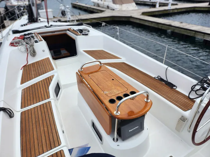 Vilia Yacht Photos Pics 2010 Jeanneau 45DS sailboat cockpit with teak seating and navigation equipment at marina.