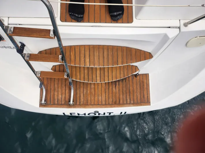 Vilia Yacht Photos Pics Jeanneau 45DS 2010 yacht stern with wooden steps and water view.