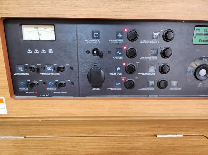 Vilia Yacht Photos Pics Control panel of a 2010 Jeanneau 45DS sailboat, featuring various switches and indicators.