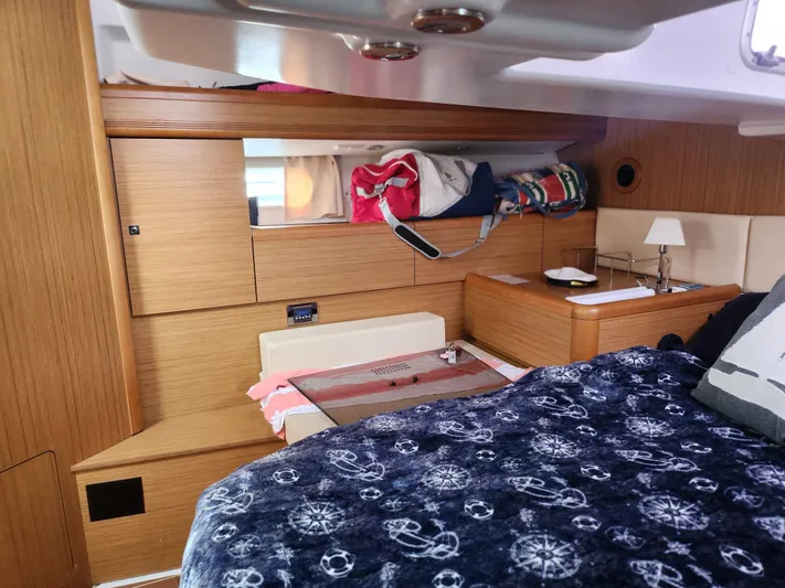 Vilia Yacht Photos Pics Cozy interior cabin of 2010 Jeanneau 45DS sailboat with wooden finish and nautical decor.