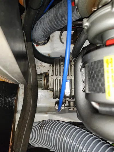 Vilia Yacht Photos Pics Engine compartment of a 2010 Jeanneau 45DS sailboat, showing mechanical components and hoses.