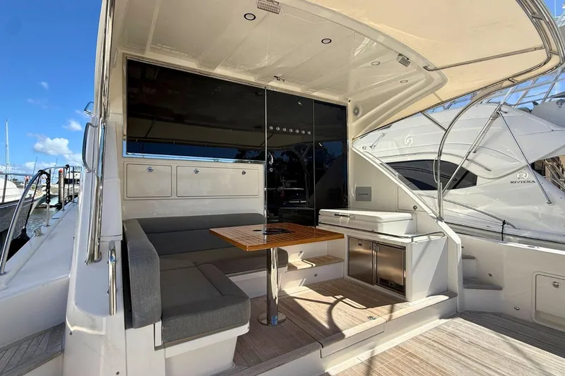 Buzz Yacht Photos Pics 2020 Riviera 57 Enclosed Flybridge yacht with outdoor seating and kitchenette.