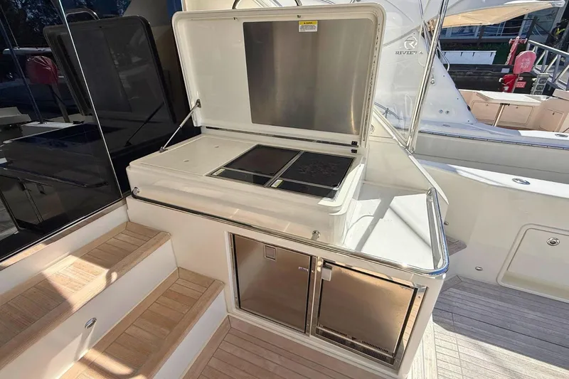 Buzz Yacht Photos Pics Outdoor kitchen on 2020 Riviera 57 Enclosed Flybridge yacht with grill and storage.