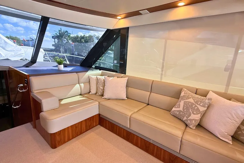 Buzz Yacht Photos Pics Luxurious interior of 2020 Riviera 57 Enclosed Flybridge yacht with plush seating and decor.