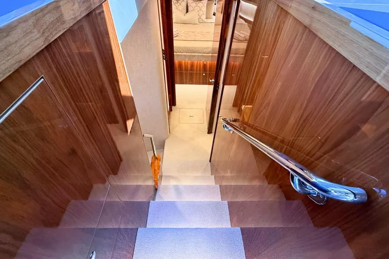 Buzz Yacht Photos Pics Staircase in 2020 Riviera 57 Enclosed Flybridge yacht with wooden paneling and modern design.